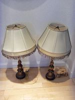 Full view of two wooden desk lamps side by side with cream silk fringe shades, showing overall style and condition.