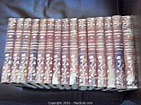 Photo of 15 volumes of John L Stoddard Lectures showing worn spines and consistent marbled covers.