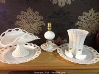 Lot shown on wooden surface with large decorative wallpaper background