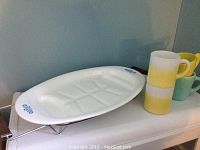 White oval Corningware platter with blue floral accents on ends