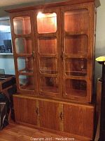 Full view of the Sklar Peppler hutch showing glass-paneled upper cabinet doors and wooden lower cabinet doors.