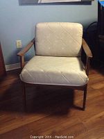 Front view showing wood frame and beige seat and back cushions