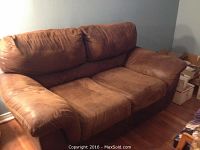 Front view of chocolate brown couch showing cushioned armrests, backrests, and seating area, with no visible rips or tears.