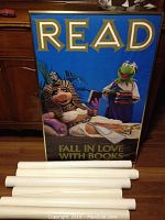 Framed Muppet poster with blue background featuring Kermit the Frog and Miss Piggy, promoting reading books.