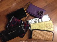 Overview of all 7 wallets arranged on floor, showing variety of colors and textures