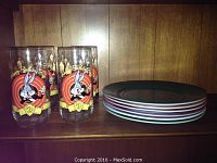 Six vintage colored plates stacked horizontally, showing different colors including pink, green, blue, and purple.