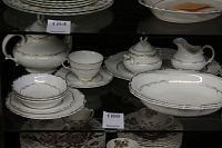 Wide view of teapot, creamer, sugar bowl, cups, saucers and oval platter.