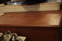 Top view showing the chest's hinged lid wooden surface with scratches and wear.