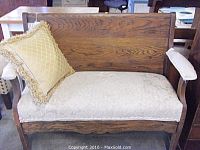 Front view of custom solid wood bench with upholstered seat and a decorative throw pillow.