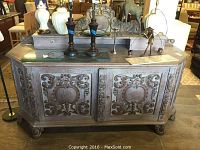 Front view showing entire sideboard with carved floral panels