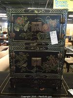 Front view of the stacked detachable cabinets showing detailed floral painting and metal handles and hinges.