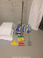 Photo showing the five partial grout and tile mortar bags, green sanding tool with handle, yellow grouting sponge, drywall sanding sponge, yellow application tool, mixing tool and scraper.