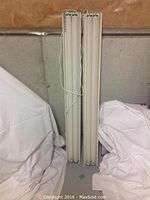 Two 48-inch long fluorescent light fixtures standing upright, showing their full length and tubes