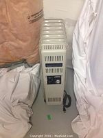 Full view of the Celebrity CH7000 electric space heater showing vertical fins, power cord, and overall condition.