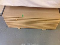 Stack of 11 oak veneered stair treads laid horizontally showing thickness and length