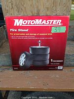 Front of unopened Motomaster tire stand box, showing brand, product image, and specifications.