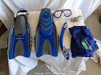 Full set of SeaDoo snorkel kit including flippers, snorkel, goggles and carry bag displayed on white cloth.