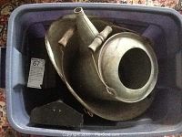 Coal bucket, metal funnel, and other metal items in plastic bin.