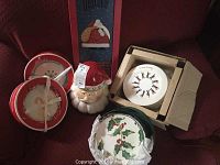 Photo showing the Santa Claus cookie jar, a dessert plate with a dancing figure design, and other Christmas plates.