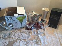 All barware included in the lot visible together on a table, showing margarita glasses, ice bucket, bar utensils, and Beleek vase with box