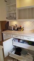 Overview of countertop showing Breville 4-slice toaster, Cuisinart kettle, spice set on lazy susan, and cabinets with glassware and kitchen items.