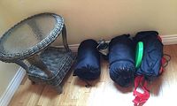 Full view of wicker table on left and assorted camping gear on right