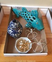 Lot contents including ginger pot, ceramic fish, jeweled crowns, and starfish