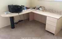 Full view of L-shaped desk with attached 3-drawer file cabinet and black support leg, showing size and shape.