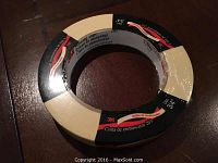 Close up of a single roll of 3M masking tape showing labeling and tape width (18mm, 3/4 inch approx).