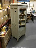 Front angled view showing entire wardrobe including beveled mirror on door and overall shape.