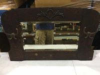 Front view of antique oak entrance mirror with mirror glass and carved top decoration