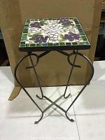 Front view of the foldable metal side table with mosaic grape tile top.