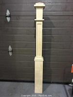 Full view of the maple wood post showing its height and square base.