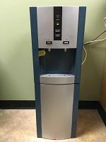 Full front view of water cooler and heater unit showing its overall form and color scheme.