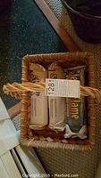 Top view of woven basket showing inside contents (not included): two wrapped packages and one rectangular box.
