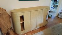 Front view of woven grass cloth buffet cabinet with center doors and side shelves