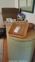 Overall view showing French Press box, two microwaveable soup mugs with lids, two small woven trays on ottoman.