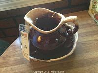 McCoy brown and tan stoneware pitcher and matching bowl set on wooden surface, clearly showing the glaze and scalloped edges