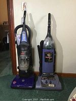 Front view of two upright vacuum cleaners: Bissell Powerforce on left and Hoover Wind Tunnel on right