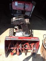 Front view of MTD Yard Machine snow blower showing the auger blades and snow intake area.