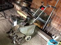 Side view of Craftsman rototiller showing engine, tines, and wheels.