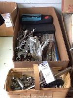 Box with various socket wrenches, sockets, and tap and die set case inside.