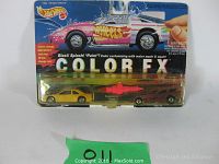 Two Hot Wheels Color FX cars in original packaging, one yellow Thunderbird and one red Funny Car, plus customizing tool. Packaging shows some wear.