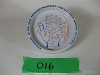 Full view of shallow white porcelain trinket dish with blue hand palmistry illustration and text around rim.