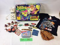 Full lot overview showing all toys, games, t-shirt, glove, and clock arranged