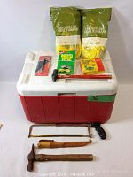 Full set of items on top of Coleman cooler showing entire lot content