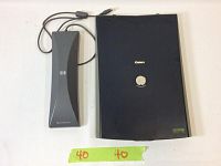 Canon CanoScan LiDE 20 flatbed scanner and HP ScanJet TMA holder shown side by side