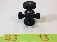 Front view of Giottos MH-1 ball head tripod mount showing the three control knobs and mounting screw on top.