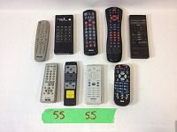 Photo shows ten used remote controls arranged in two rows of five on a white background. Tape labeled '55' is in front of remotes.