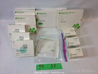 Several boxes of Mepilex and Mefix medical pads displayed showing brand and packaging.